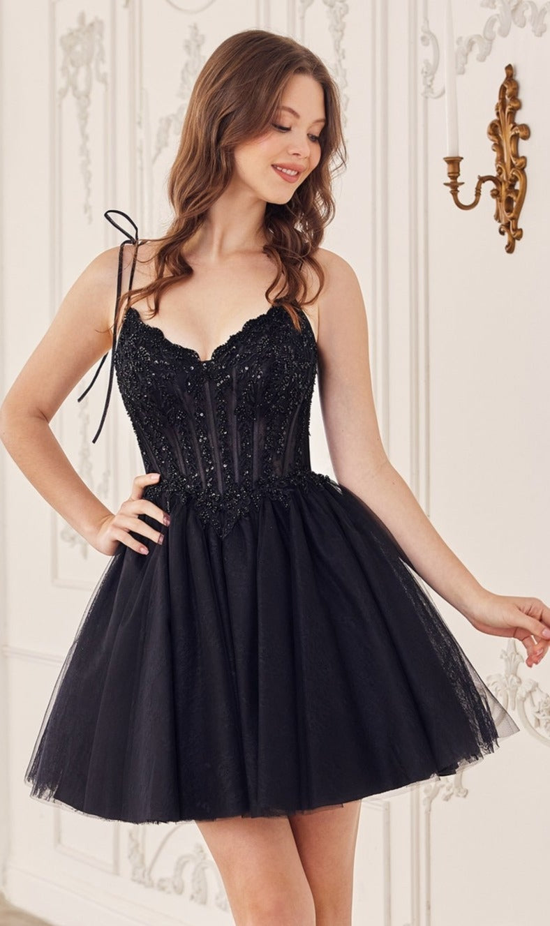 A woman stands smiling with one hand on her hip in an ornate, light room, wearing the Ladivine Embroidered Lace Homecoming Dress CD0236—a short dress with spaghetti straps and detailed lace embroidery.